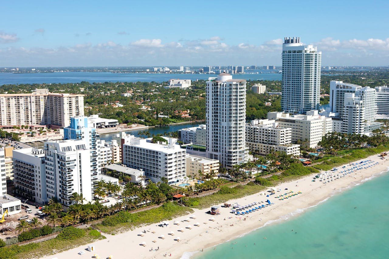 White concrete buildings near a beach